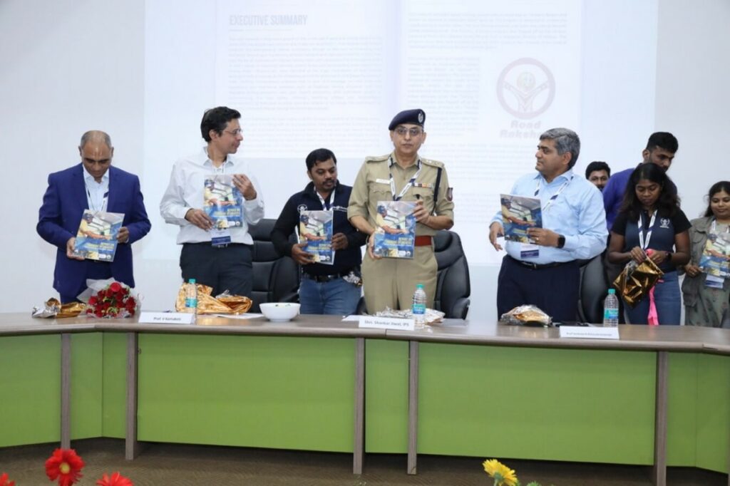 Shri Shankar Jiwal and Professor Kamakoti releasing the report of the 'Train the Trainer' programme for school bus drivers