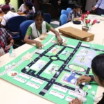 Participants place road signage on the road map