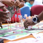 Participants place road signage on the road map