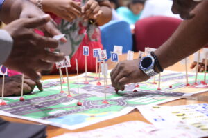 Participants place road signage on the road map